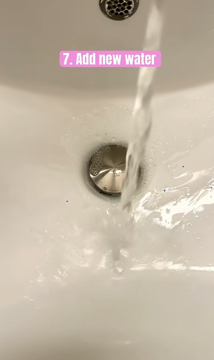 Clean water running into a sink to rinse the oil off
