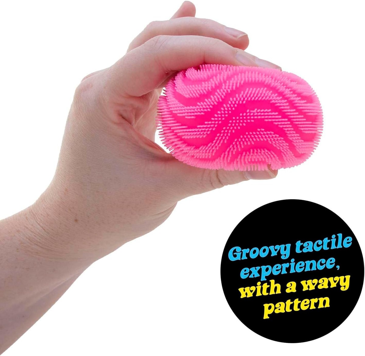 NeeDoh Fuzz Ball Wonder Waves — pink ball being squeezed