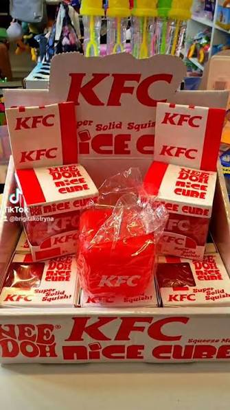 Store display box filled with KFC NeeDoh squishy cubes
