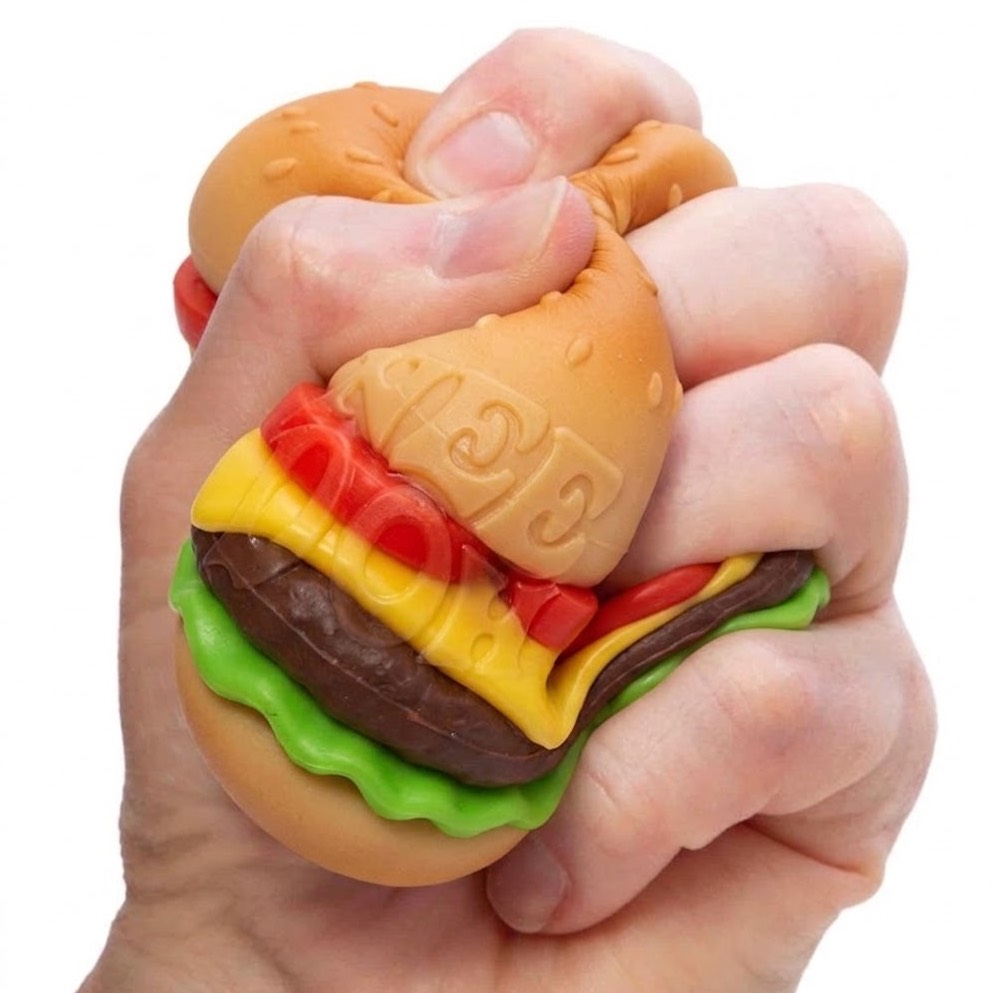Fist squeezing the burger squishy showing NeeDoh lettering on the bun