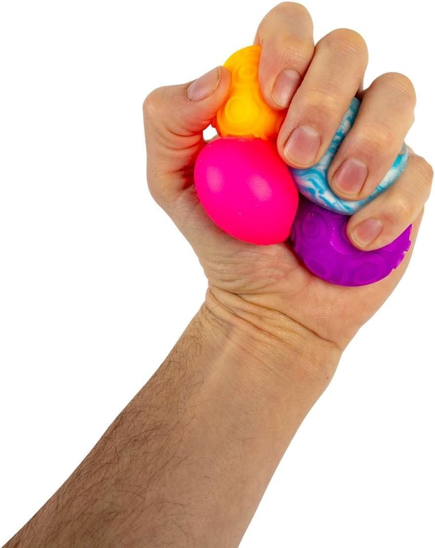 NeeDoh Teenie Singles — miniature balls being squeezed in one hand